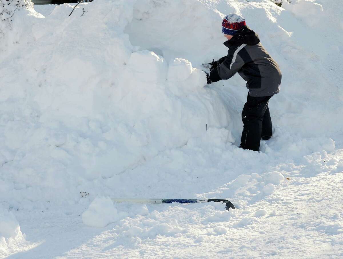 Dylan Hutzelmann makes an igloo in his driveway in Fairfield, Conn. on Friday, Feb. 9, 2013. Southwestern Connecticut was hit by one of the biggest snowstorms in history, a howling blizzard that dumped over two feet of snow across the area.