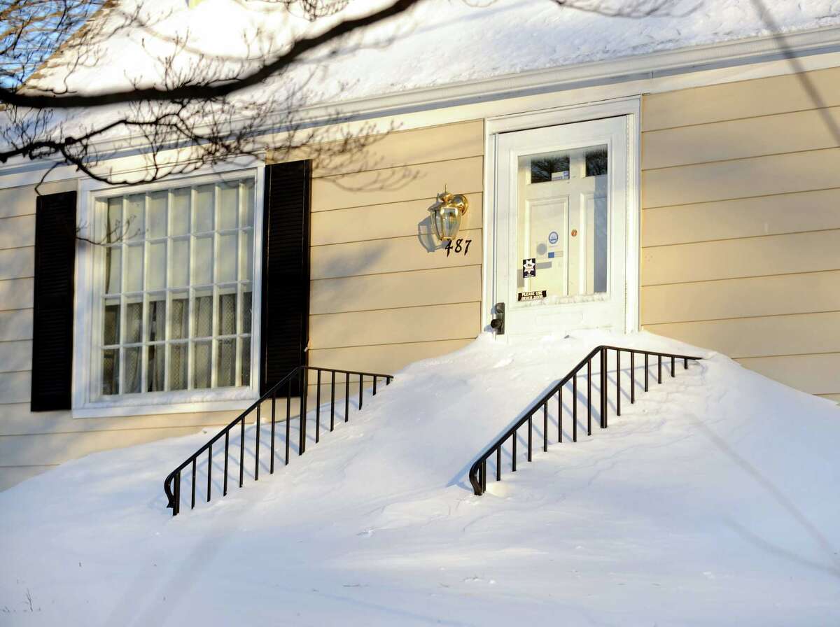 Snowdrifts went halfway up the door on this home Fairfield, Conn. on Friday, Feb. 9, 2013. Southwestern Connecticut was hit by one of the biggest snowstorms in history, a howling blizzard that dumped over two feet of snow across the area.