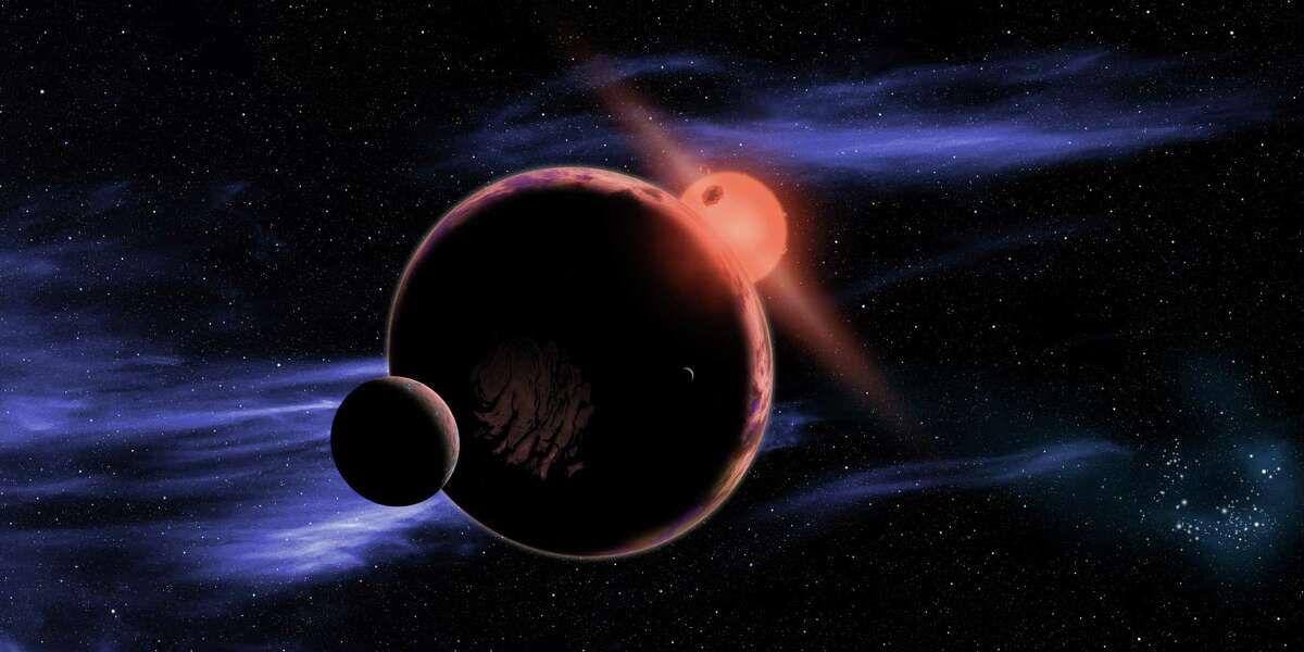 This artist's conception shows a hypothetical planet with two moons orbiting in the habitable zone of a red dwarf star.