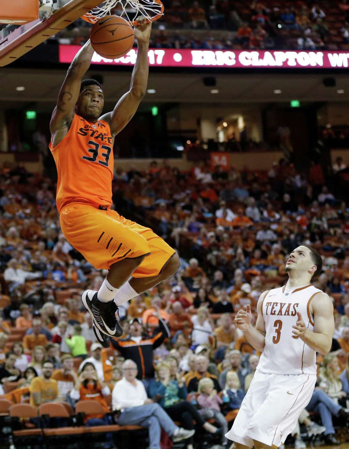 Oklahoma State's Marcus Smart (33) puts the finishing touch on two of his 23 points as Texas' Javan Felix (3) does little more than watch in the second half.