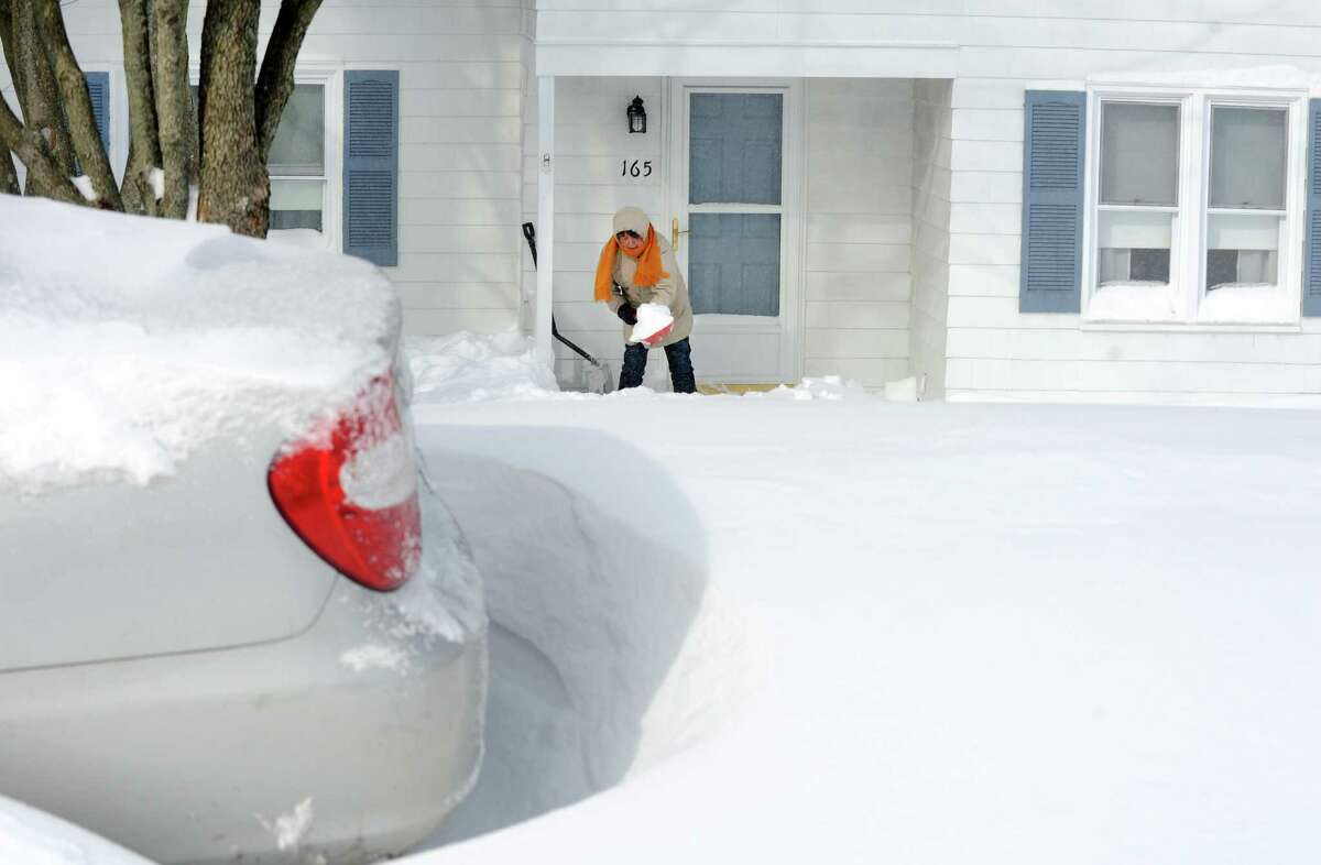 A residents on Burroughs Rd. shovels her entrance after a overnight blizzard dumped over two feet of snow in Fairfield, Conn. on Saturday, Feb. 9, 2013.