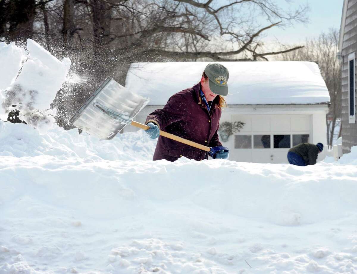 Sandra Pederzini and her husband Matthew Fiedler shovel their driveway on Judd St. in Fairfield, Conn. on Saturday, Feb. 9, 2013. Southwestern Connecticut was hit by one of the biggest snowstorms in history, a howling blizzard that dumped up to three feet of snow across the state.