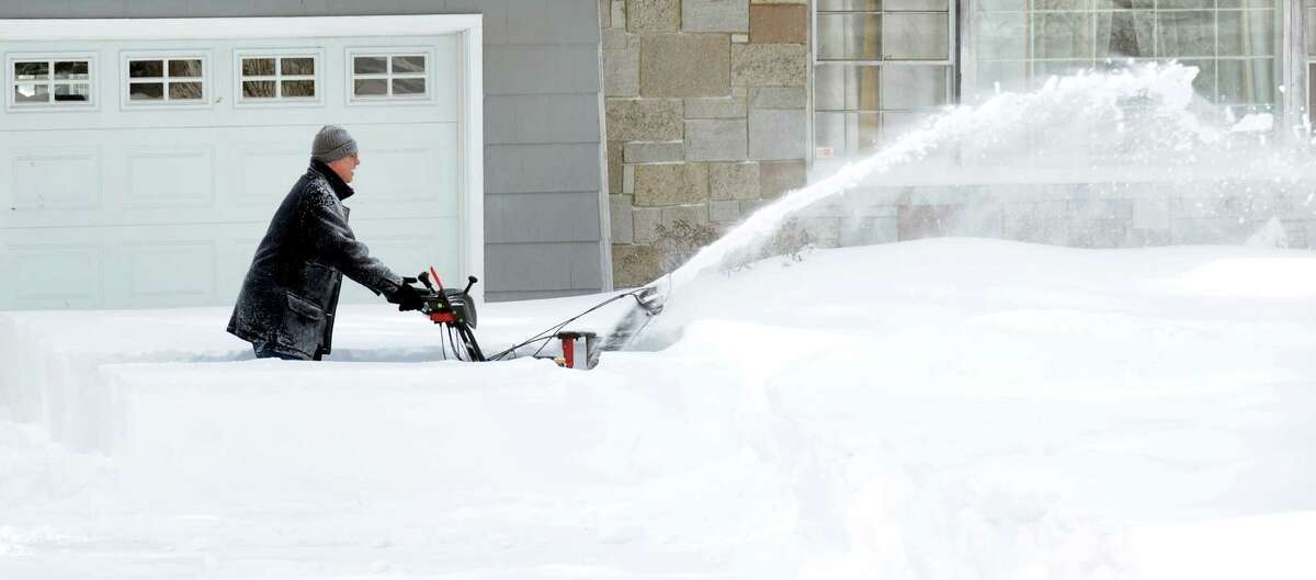 A resident on High Street clears his driveway after a overnight blizzard dumped over two feet of snow in Fairfield, Conn. on Saturday, Feb. 9, 2013.