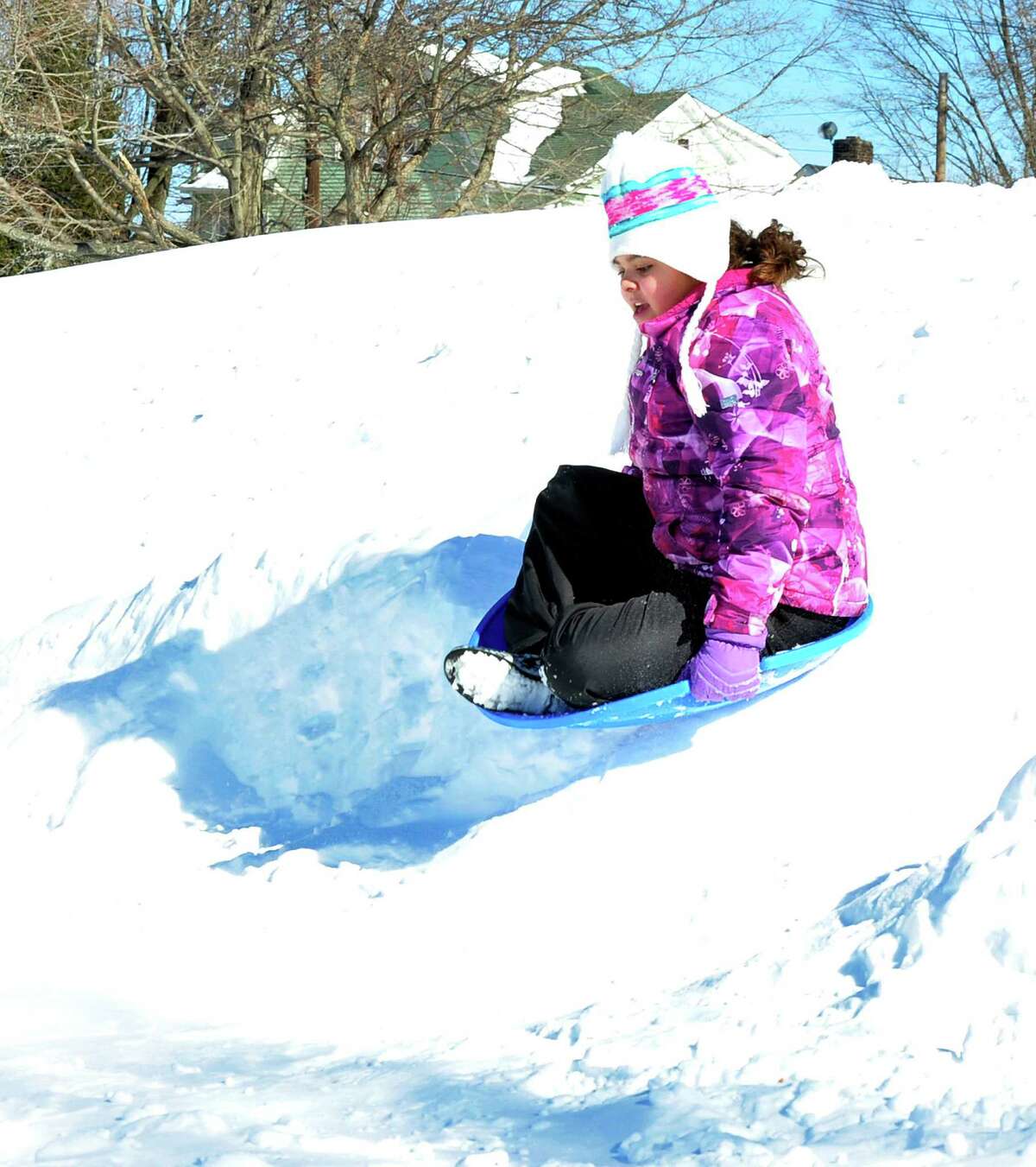 Alexandria Wilson, 10, goes over a jump while sledding at Broadview Middle School in Danbury, Sunday, Feb. 10, 2013.