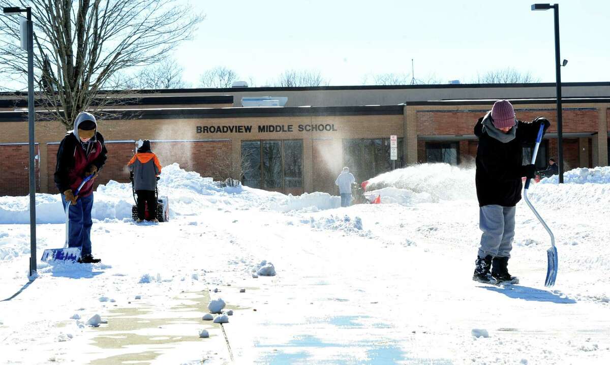 Workers clear snow outside Broadview Middle School in Danbury, Sunday, Feb. 10, 2013.