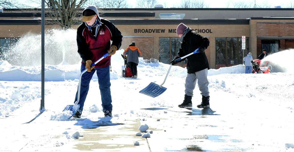 Workers clear snow outside Broadview Middle School in Danbury, Sunday, Feb. 10, 2013.