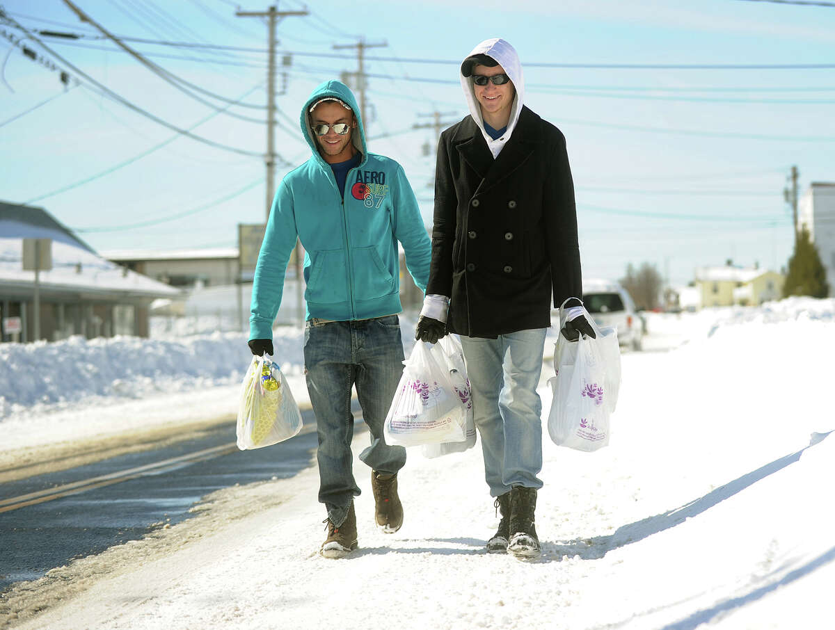Tom LeConte, left, and Joe Leck of Milford walk two miles each way to carry groceries to their snowed in apartment complex in Milford, Conn. on Sunday, February 10, 2013.