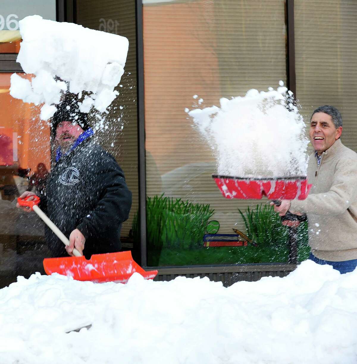 Charlie Hall, left, and Carl Bailey, shovel out of the snow in Danbury Sunday, Feb. 10, 2013.