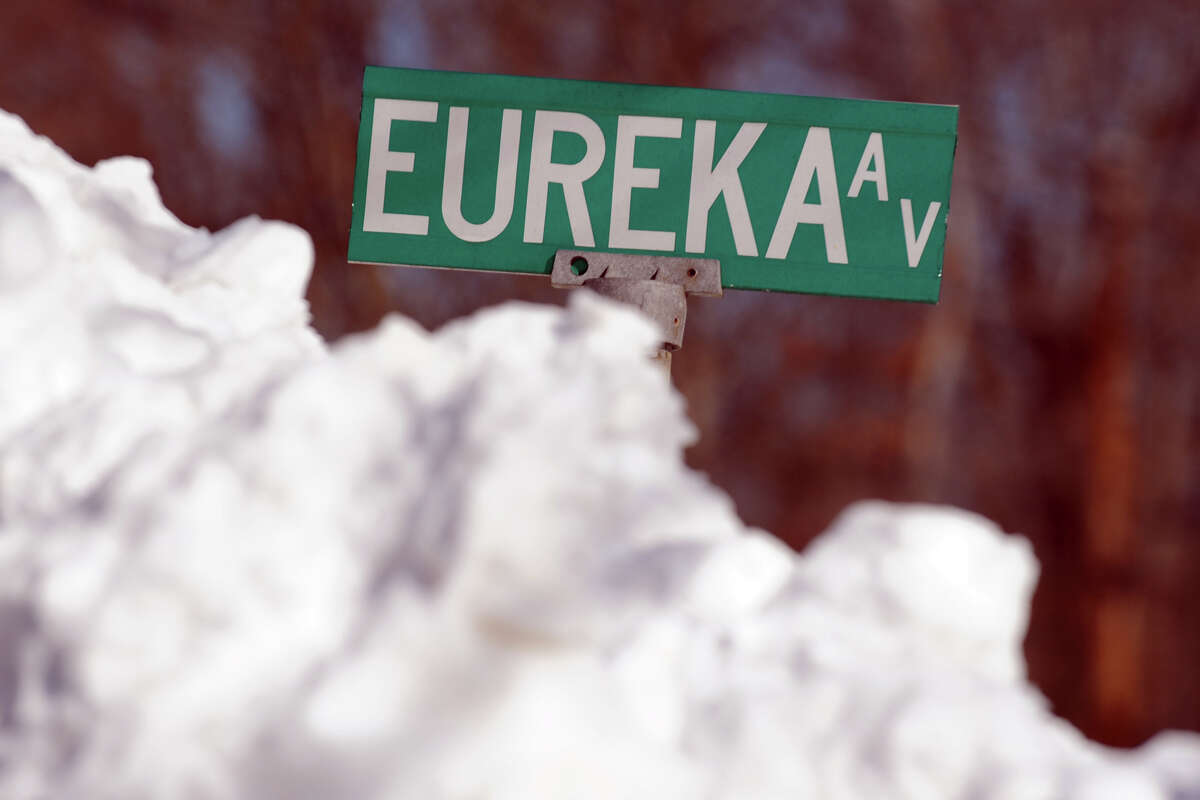 Plowed snow stands as high as the street sign on Eureka Ave., in Stratford, Conn., Feb. 10th, 2013.