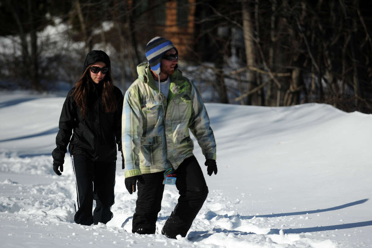 Michael Patria and Jessica Tumio walk in the snow on an unplowed section of Cutspring Rd., in Stratford, Conn., Feb. 10th, 2013.