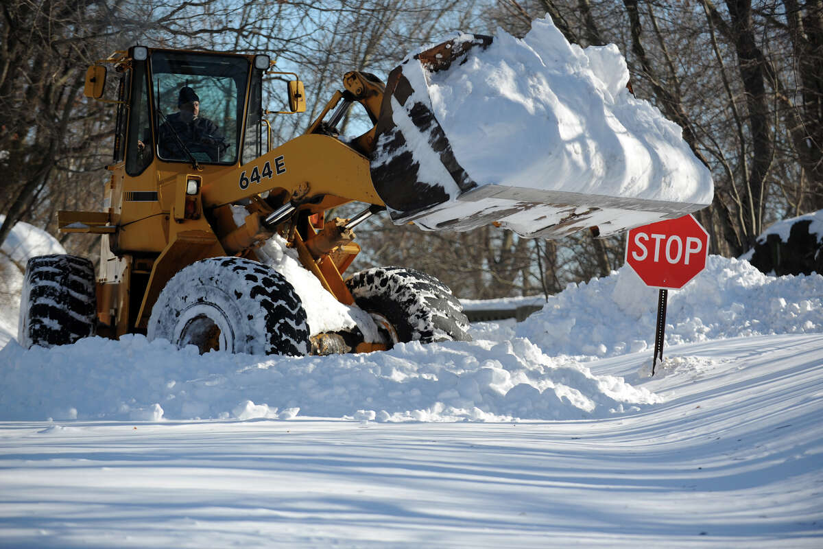 A tractor begins to remove snow from a section of Cutspring Rd., in Stratford, Conn., Feb. 10th, 2013.
