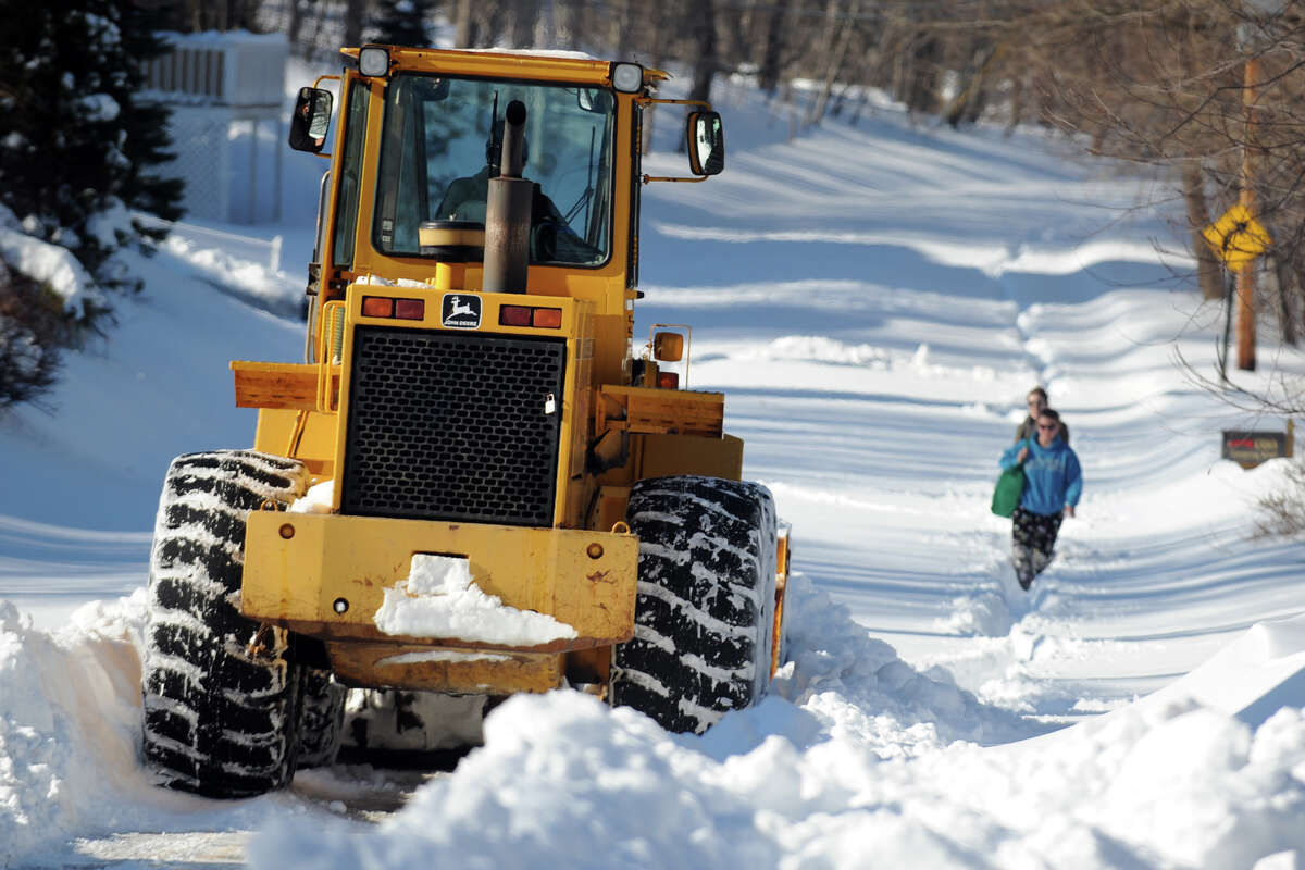 A tractor makes the first trip to remove snow from the north end of Cutspring Rd., in Stratford, Conn., Feb. 10th, 2013.
