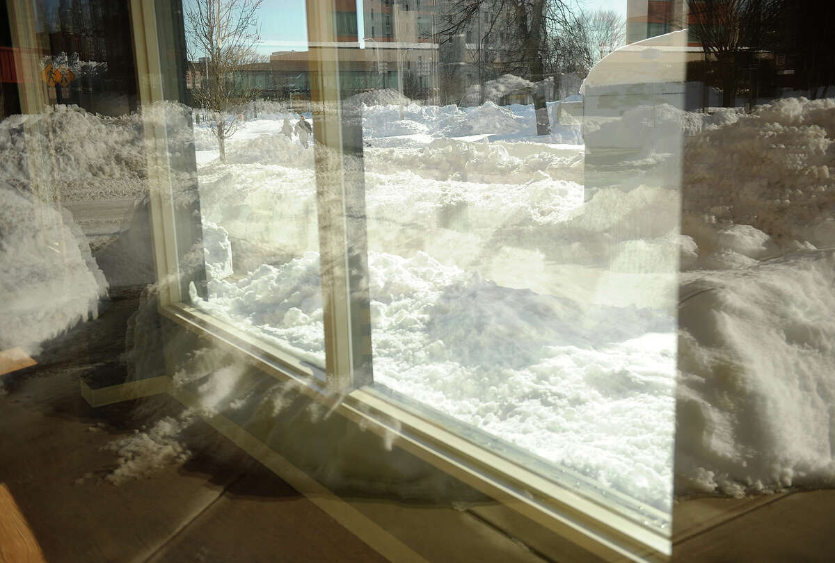 Mountains of snow are piled up along the streets in the Lafayette Circle area of Bridgeport, Conn. on Sunday, February 10, 2013.