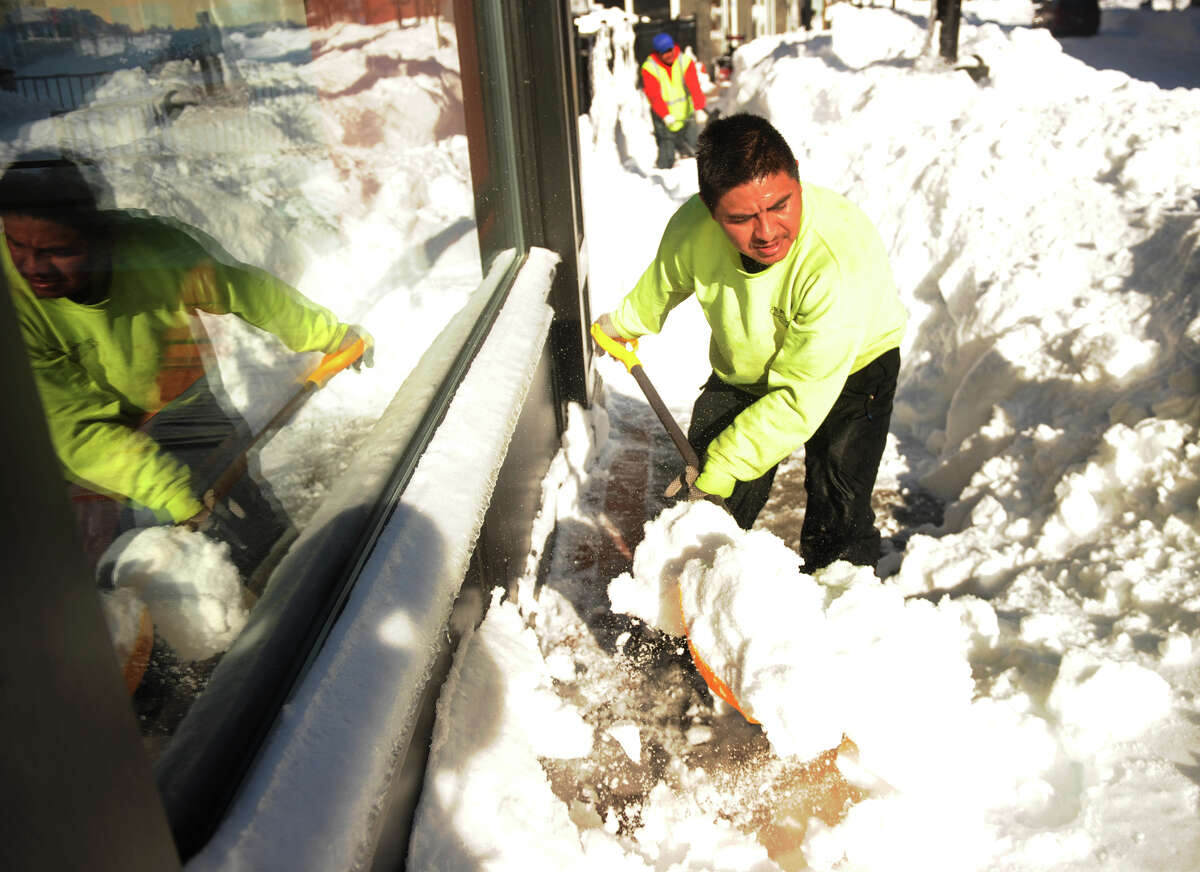 Arturo Sanchez of Bridgeport shovels sidewalks in the Bijou Square development of Fairfield Avenue in Bridgeport, Conn. on Sunday, February 10, 2013.