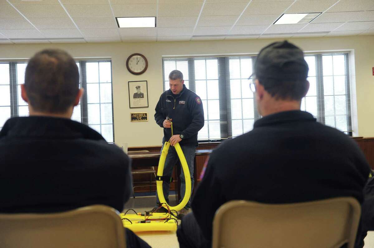 Greenwich firefighter Chief Keith Millette teaches firefighters at the Cos Cob Firehouse in Cos Cob, Conn., Feb. 7, 2013. Later, the firefighters conduct cold water rescue training on the Mianus River.