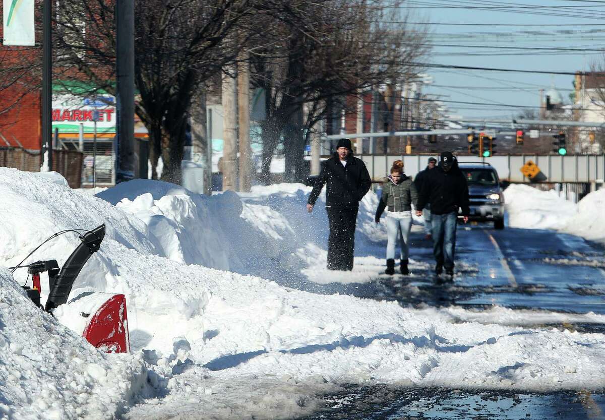 Mike Ross Connecticut Post freelance -East Side residents are forced to walk down East Main Street because sidewalks are covered in snow from Storm Nemo.