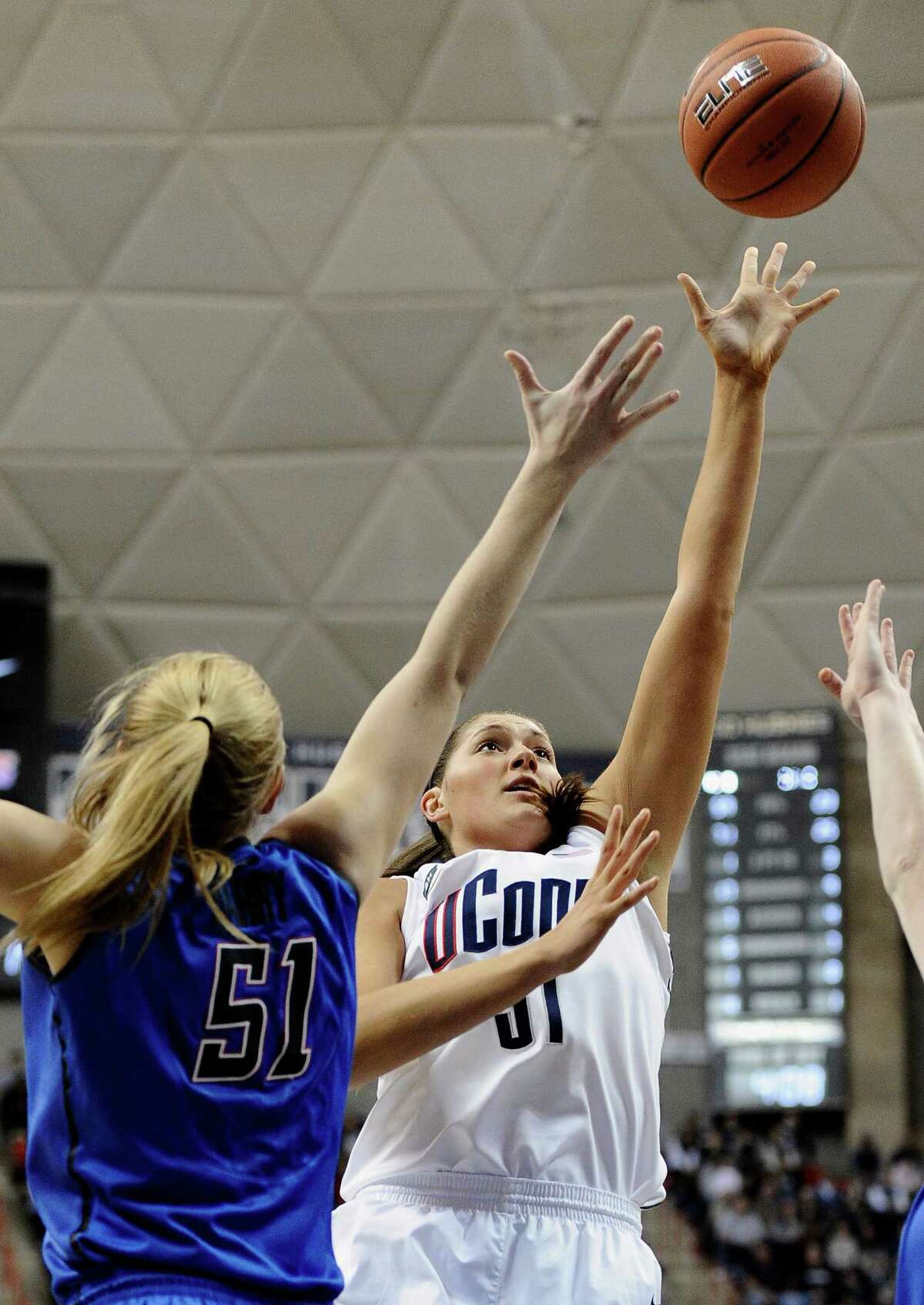 Connecticut's Stefanie Dolson, right, goes up for a basket as DePaul's Katherine Harry, left, defends during the first half of an NCAA college basketball game in Storrs, Conn., Sunday, Feb. 10, 2013. Dolson had 22 points in the first half. (AP Photo/Jessica Hill)