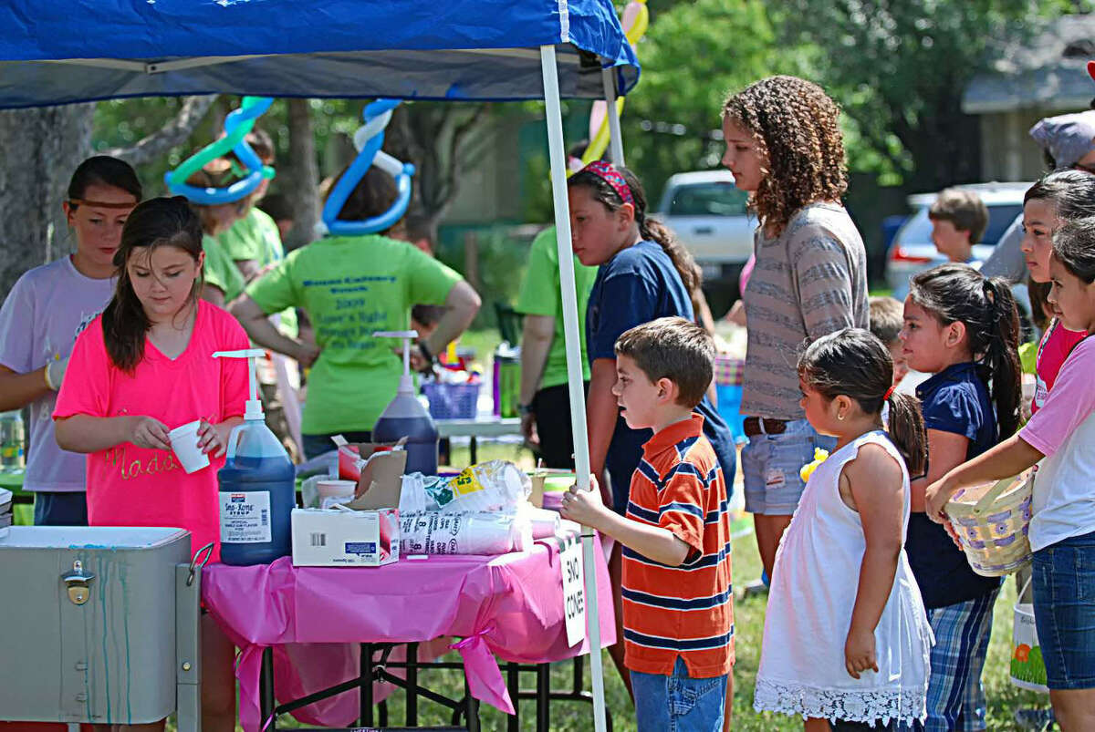 Terrell Heights residents make a snow cone stand a popular spot at a recent neighborhood association annual picnic.