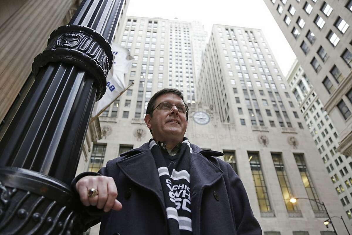 Sean Toohey, a grains broker at the Chicago Board of Trade, who had hip replacement surgery last summer ,walks home from work Monday, Feb. 11, 2013, in Chicago. Routine hip replacement surgery on a healthy patient may cost as little as $11,000 _ or up to nearly $126,000. Toohey said he has good health insurance that covered most of the costs, and it didn't occur to him to ask about price beforehand. (AP Photo/M. Spencer Green)