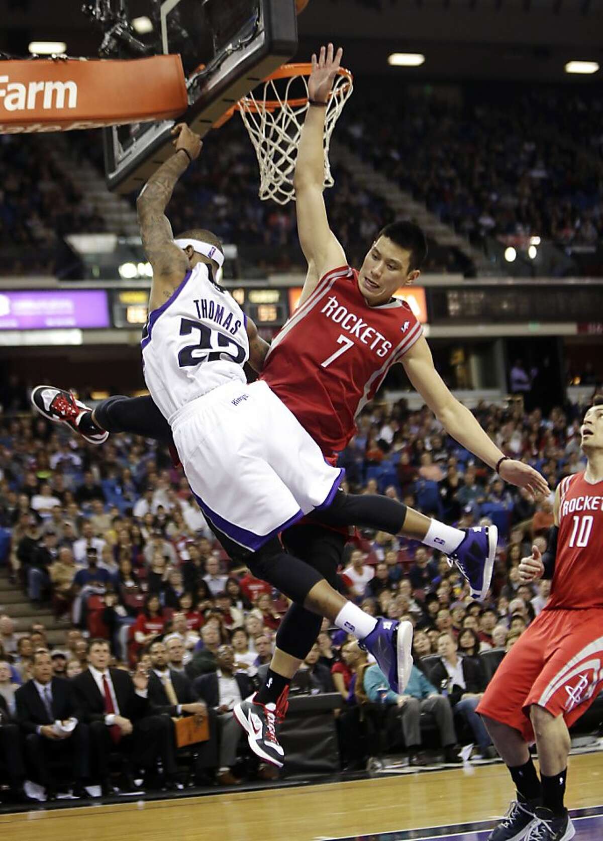 Sacramento Kings guard Isaiah Thomas, left, is fouled by Houston Rockets guard Jeremy Lin during the third quarter of an NBA basketball game in Sacramento, Calif., Sunday, Feb. 10, 2013. The Kings won 117-111. (AP Photo/Rich Pedroncelli)