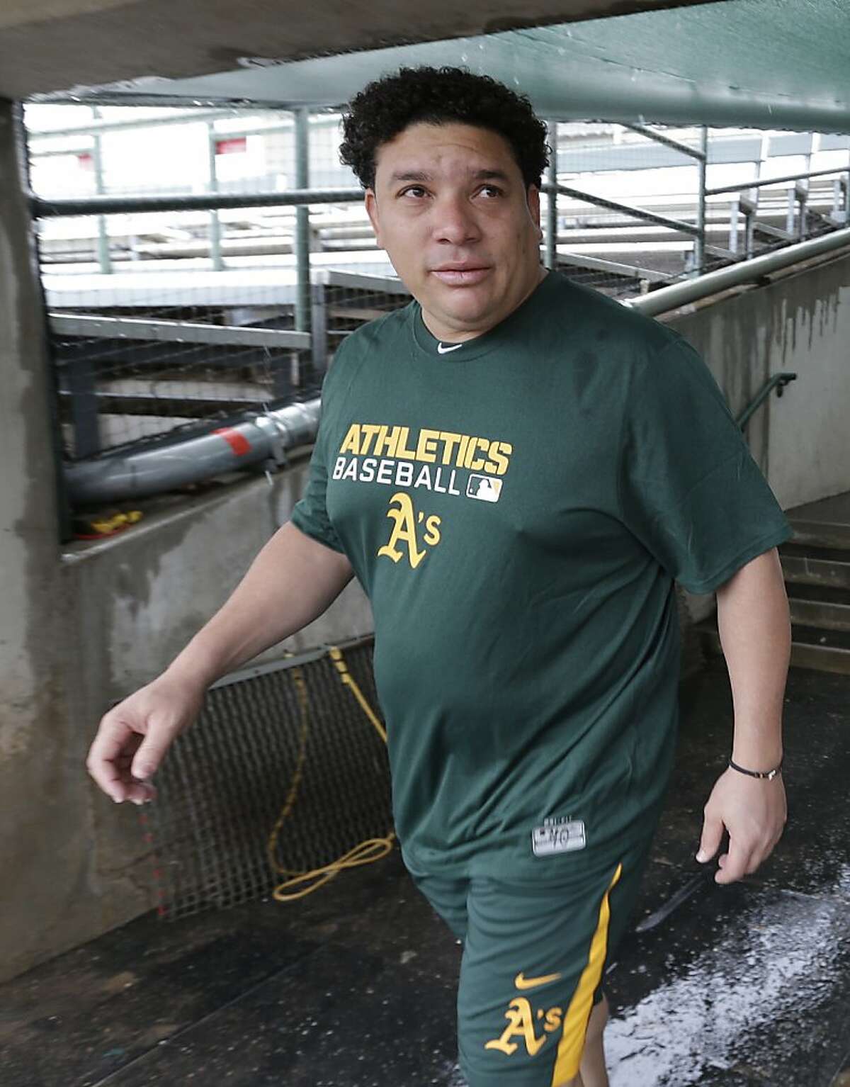 Oakland Athletics' Bartolo Colon walks to take his physical Monday, Feb. 11, 2013, in Phoenix. The Athletics' pitchers and catchers start practice Tuesday. (AP Photo/Darron Cummings)