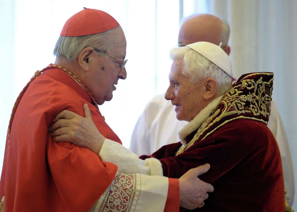 In this photo provided by the Vatican newspaper L'Osservatore Romano, Pope Benedict XVI, right, and Cardinal Angelo Sodano, Dean of the College of Cardinals, hug each other after the pontiff announced during the meeting of Vatican cardinals that he would resign on Feb. 28, at the Vatican, Monday, Feb. 11, 2013. Benedict XVI announced Monday that he would resign Feb. 28 - the first pontiff to do so in nearly 600 years. The decision sets the stage for a conclave to elect a new pope before the end of March. (AP Photo/L'Osservatore Romano, ho)