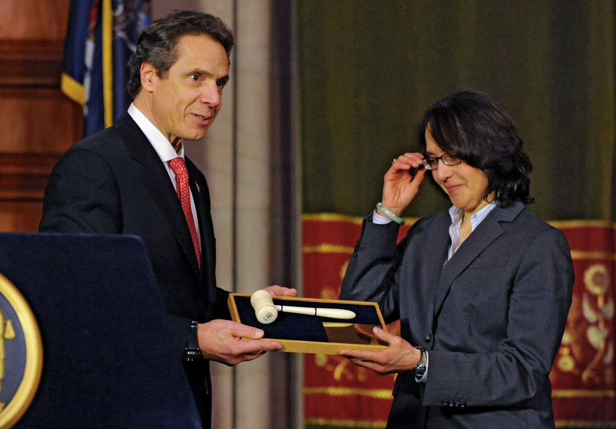 NYS Governor Andrew Cuomo presents Jenny Rivera the gavel of the late Judge Benjamin Cardozo after she is voted in as a judge on the NYS Court of Appeals by the Senate at the Capitol on Monday Feb. 11, 2013 in Albany, N.Y. (Lori Van Buren / Times Union)