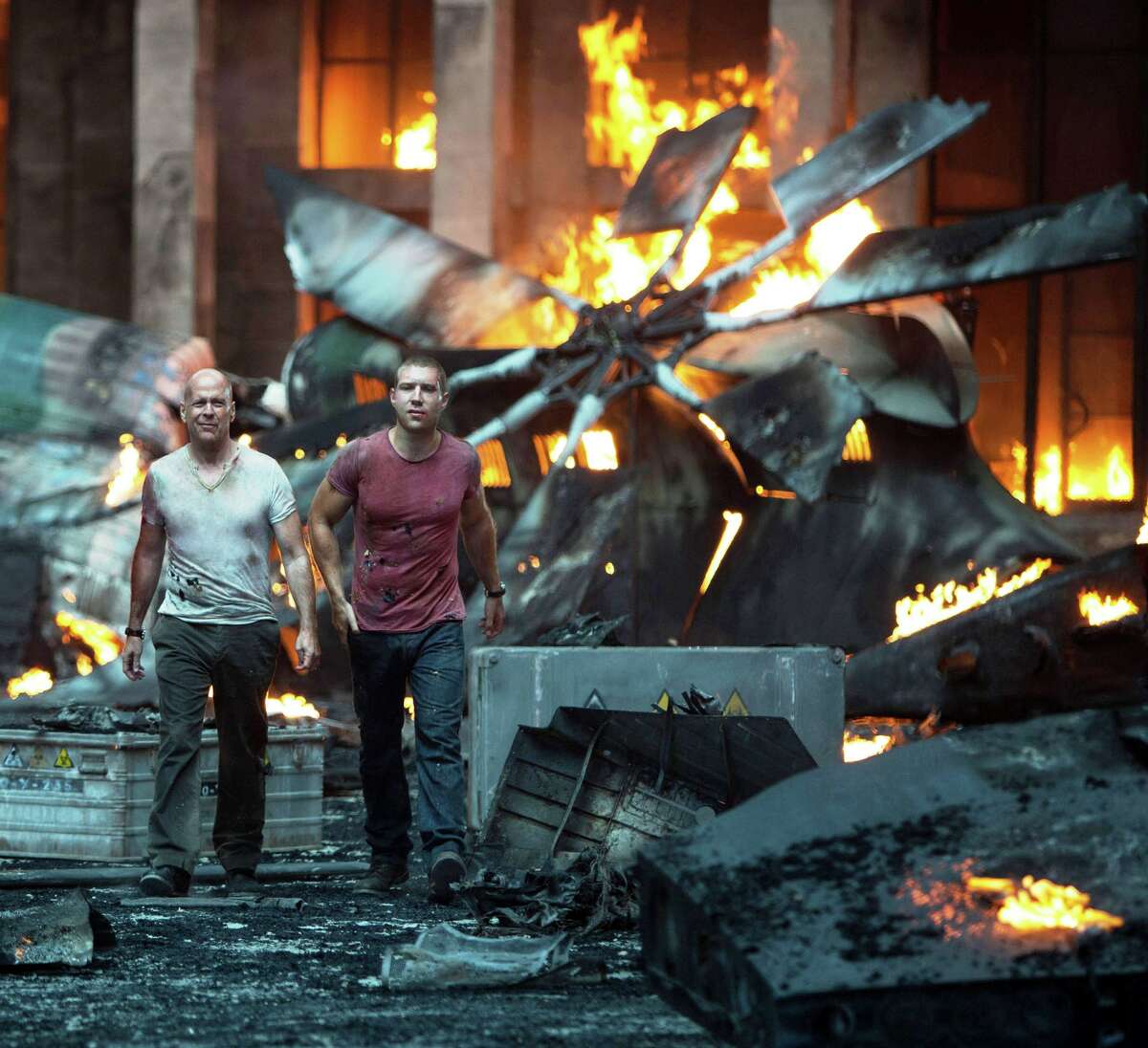 John McClaine (Bruce Willis) and his son Jack (Jai Courtney) survey the wreckage after their encounter with assassins in "A Good Day to Die Hard."