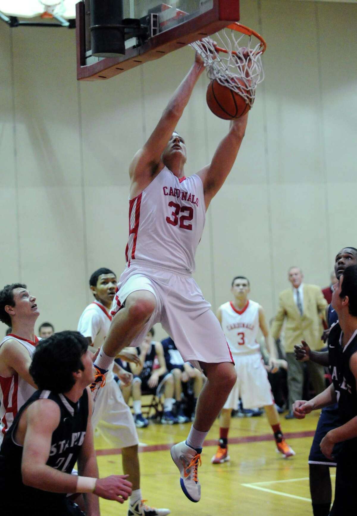 Alex Wolf # 32 of Greenwich dunks the ball during the boys high school basketball game between Greenwich High School and Staples High School at Greenwich, Tuesday, Feb. 12, 2013.