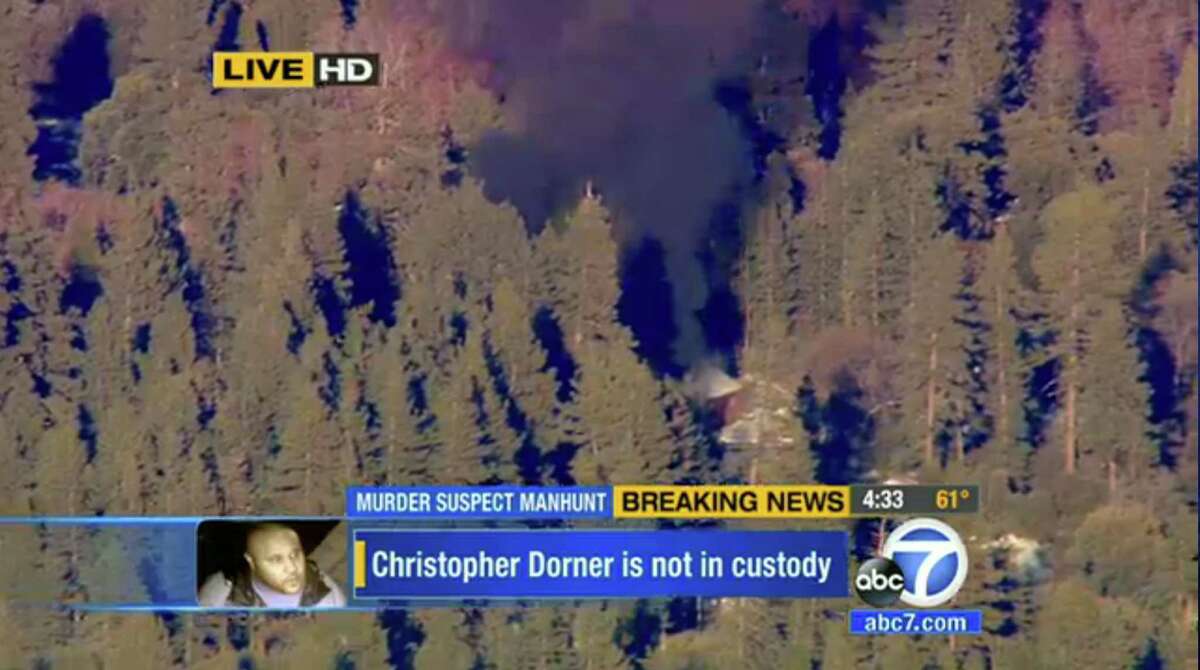 In this image taken from video provided by KABC-TV, the cabin in Big Bear, Calif. where ex-Los Angeles police officer Christopher Dorner is believed to be barricaded inside is in flames Tuesday, Feb. 12, 2013. (AP Photo/KABC-TV) MANDATORY CREDIT: KABC-TV