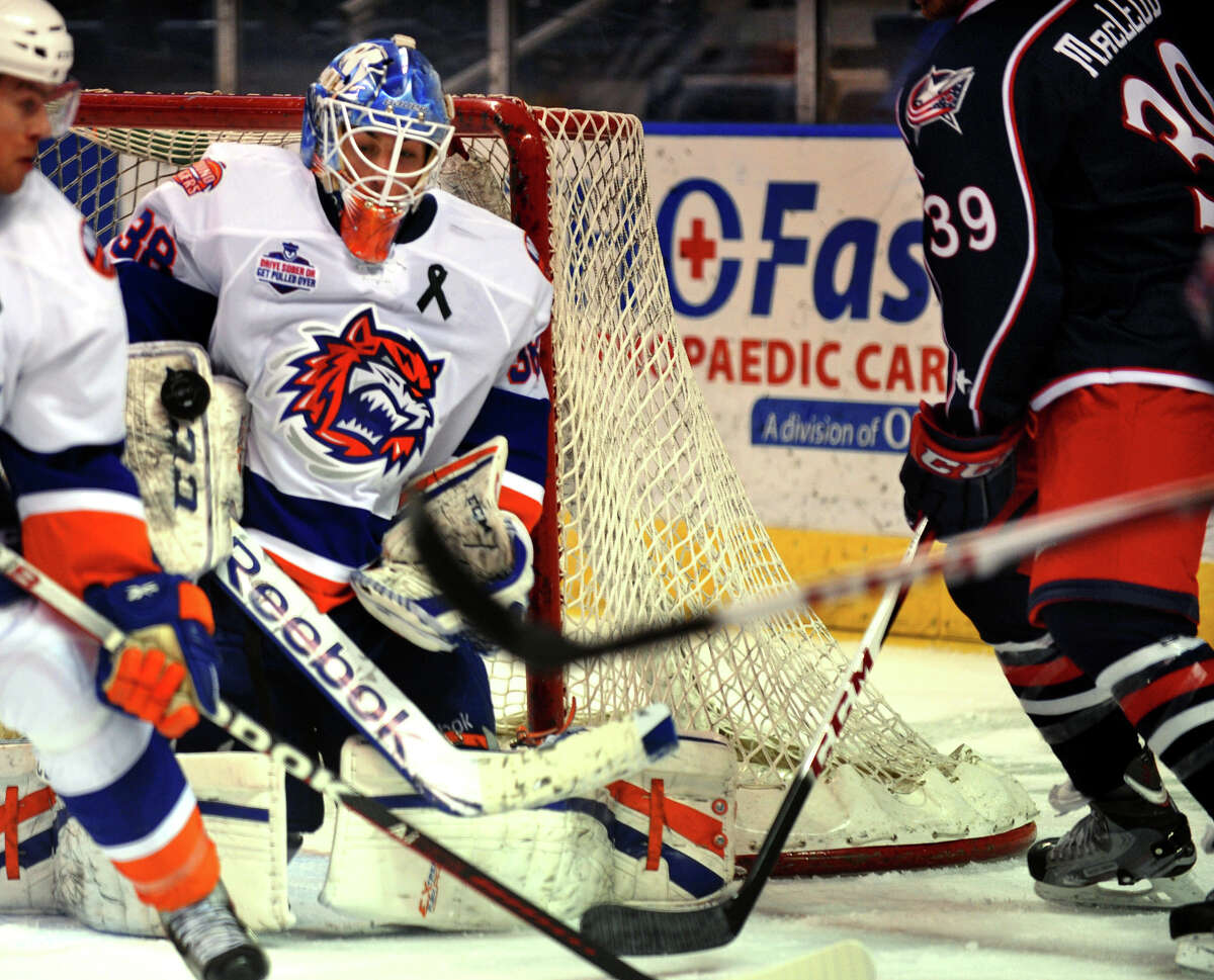 Sound Tigers goalie Kevin Poulin deflects a Springfield shot, during hockey action at the Webster Bank Arena in Bridgeport, Conn. on Tuesday February 12, 2013.