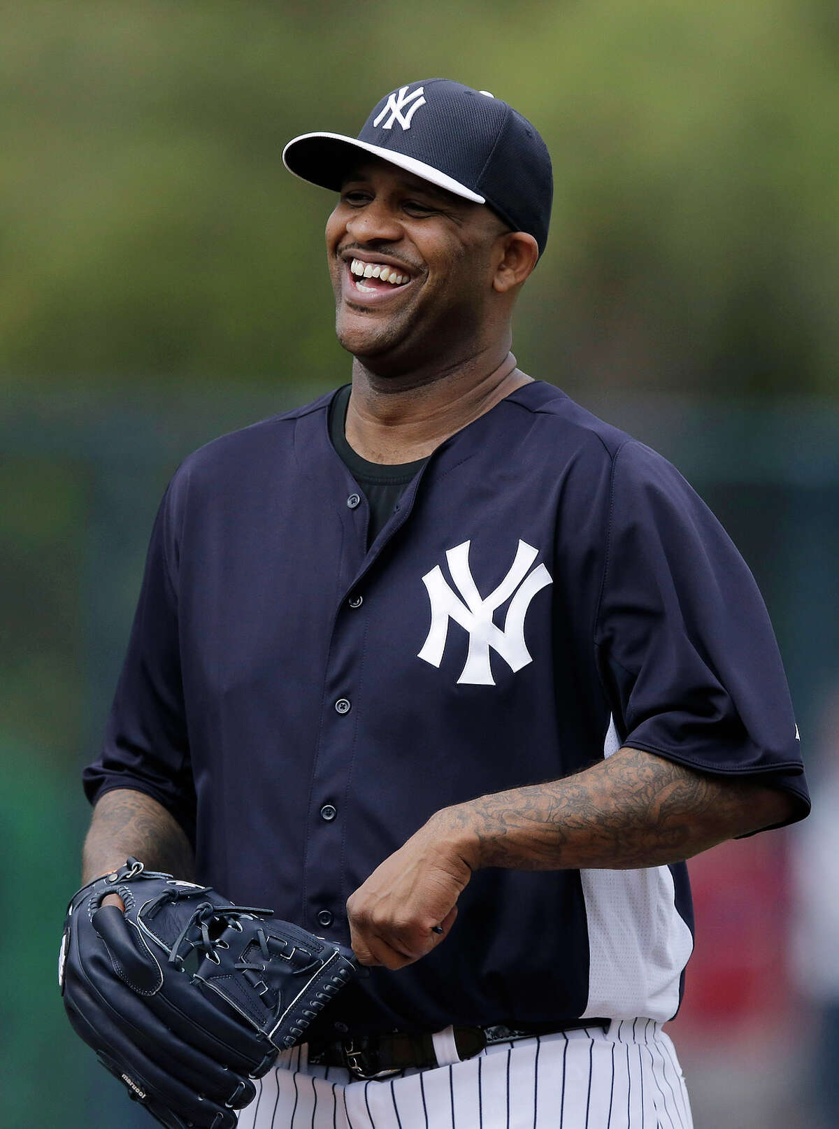 New York Yankees' CC Sabathia laughs during a workout at baseball spring training, Wednesday, Feb. 13, 2013, in Tampa, Fla. (AP Photo/Matt Slocum)