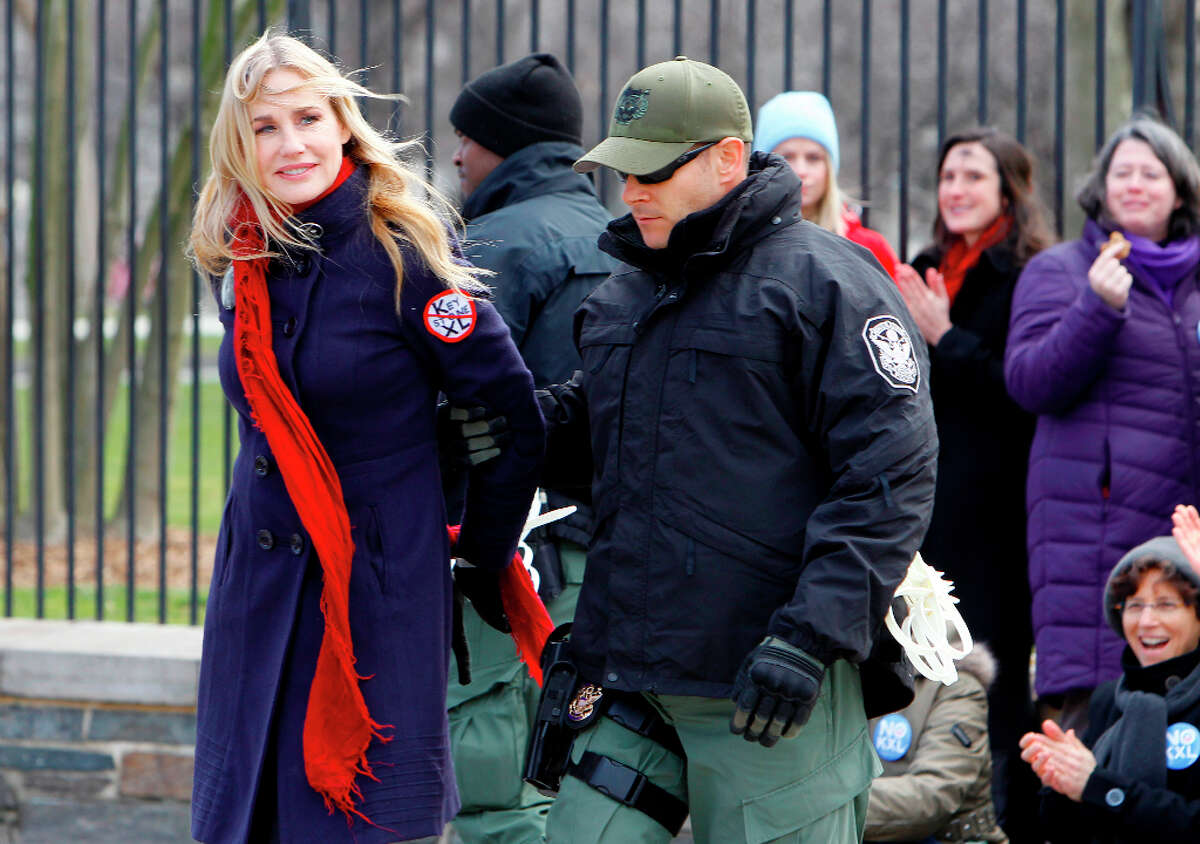Actress Daryl Hannah is arrested outside the White House in Washington, Wednesday, Feb. 13, 2013, as prominent environmental leaders tied themselves to the White House gate to protest the Keystone XL oil pipeline.