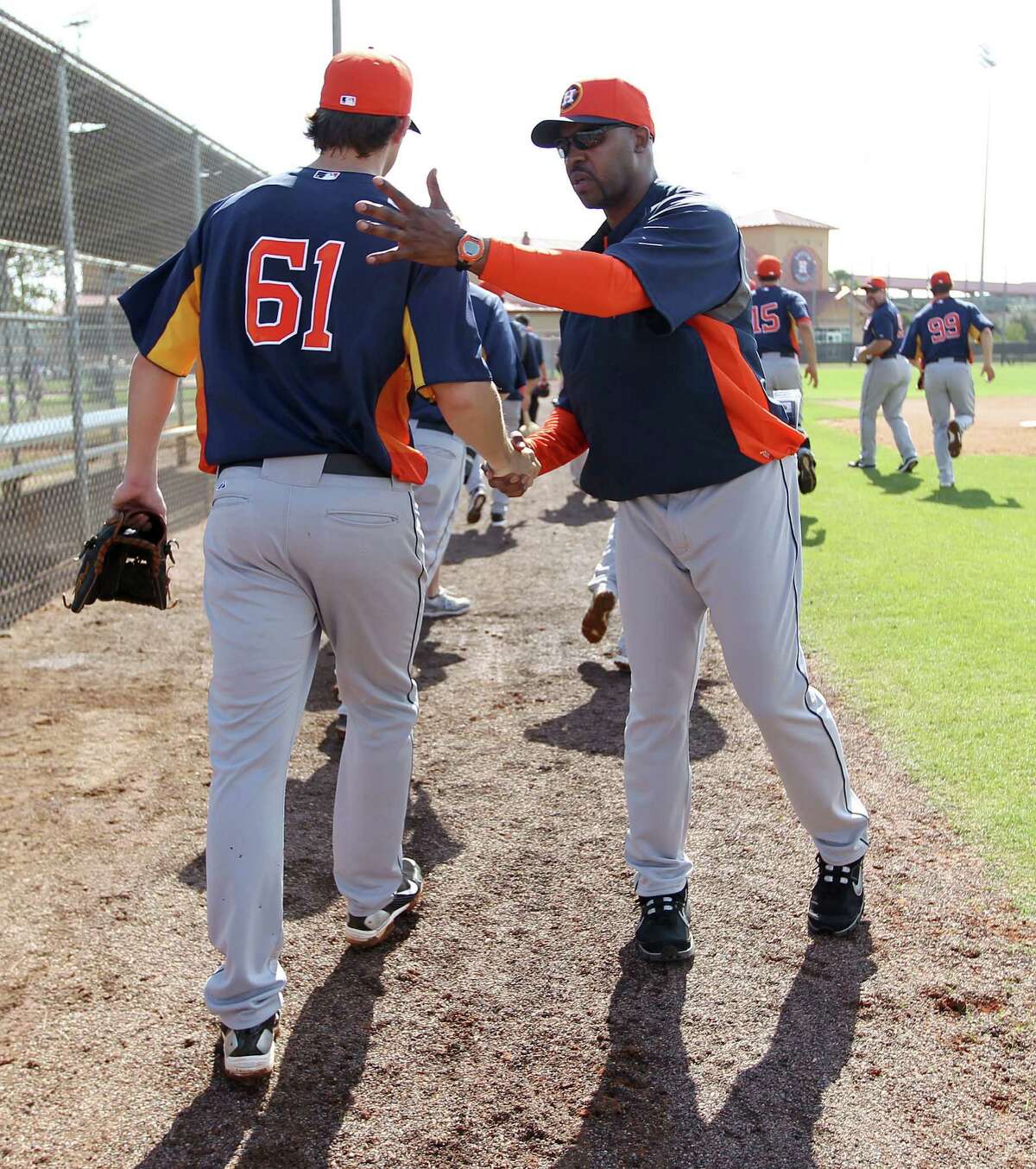 New Astros manager Bo Porter (right) shakes pitcher Ross Seaton's hand after drills Wednesday in Kissimmee, Fla. Porter's squad is preparing for its first season in the American League.
