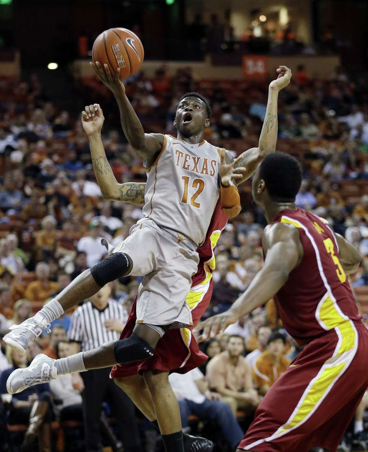 Texas' Myck Kabongo goes in for a layup as Iowa State's Melvin Ejim (3) looks on at the Erwin Center.
