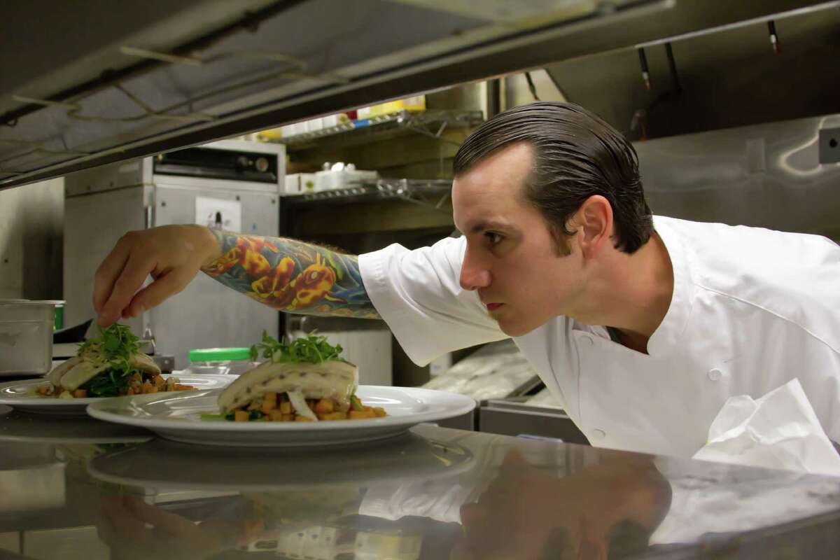 Chef Chris Cook puts finishing touches on his creation during Food Network's "Chef Wanted."