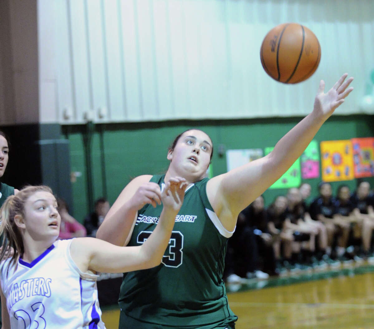 At right, Emily O'Sullivan # 33 of Convent goes for the ball along with Gianna Masini # 23 of Masters during the girls high school basketball game between Masters and Convent of the Sacred Heart at the Convent in Greenwich, Thursday, Feb. 14, 2013.