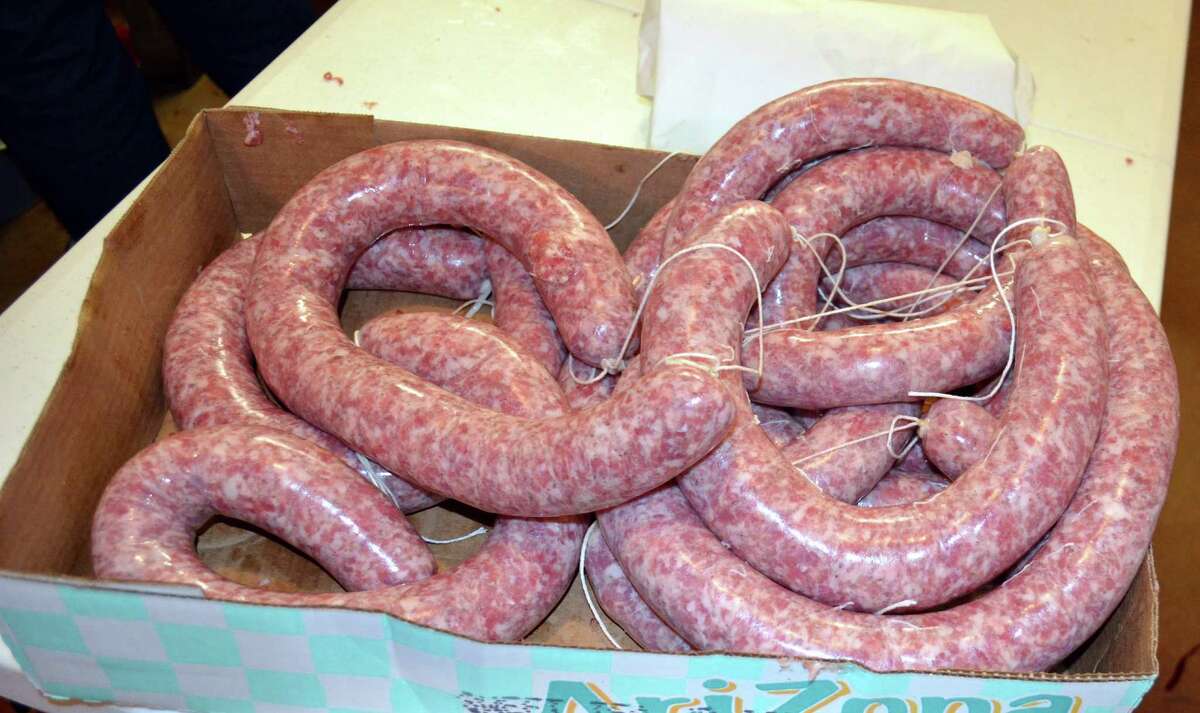 Pretty pink rings of Benny Lyssy's secret sausage are ready for a trip to the smoker.