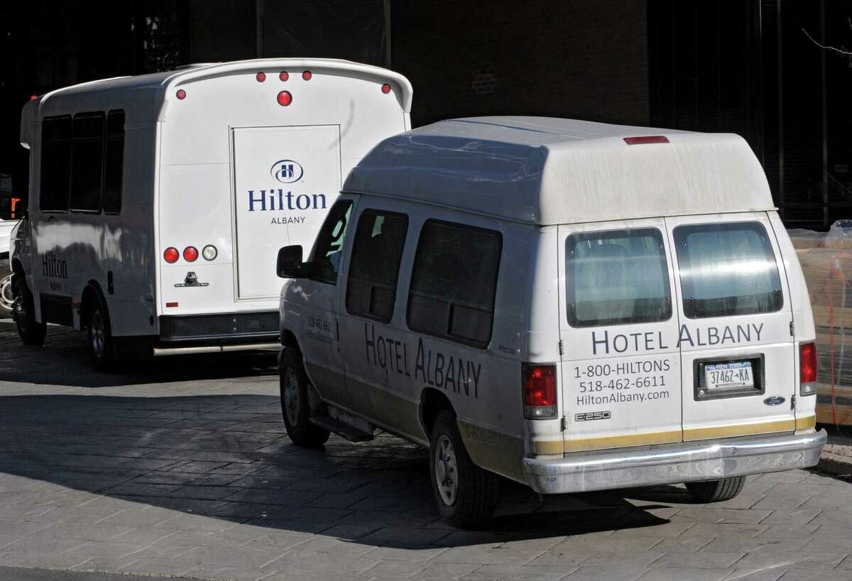 Old and new shuttle buses are parked near the front door of the Hilton hotel formerly known as Hotel Albany on Thursday Feb. 14, 2013, in Albany, N.Y. (Lori Van Buren / Times Union)