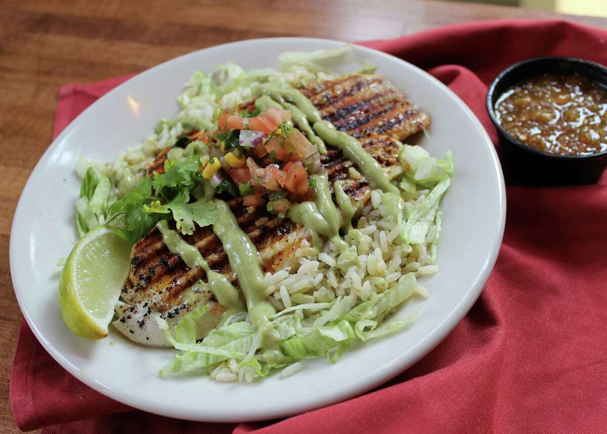 Perla?•s Pan Seared Fish & Rice at Barriba Cantina: A perfectly grilled Tilapia filet with a mild ancho chile rub and drizzled with avocado tomatillo salsa. Served on a bed of cilantro lime rice for $10.99.