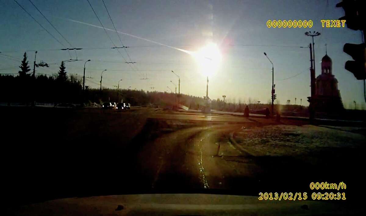 In this frame grab made from a video done with a dashboard camera a meteor streaks through the sky over Chelyabinsk, about 1500 kilometers (930 miles) east of Moscow, Friday, Feb. 15, 2013. A meteor that scientists estimate weighed 10 tons (11 tons) streaked at supersonic speed over Russia's Ural Mountains on Friday, setting off blasts that injured some 500 people and frightened countless more. (AP Photo/AP Video)