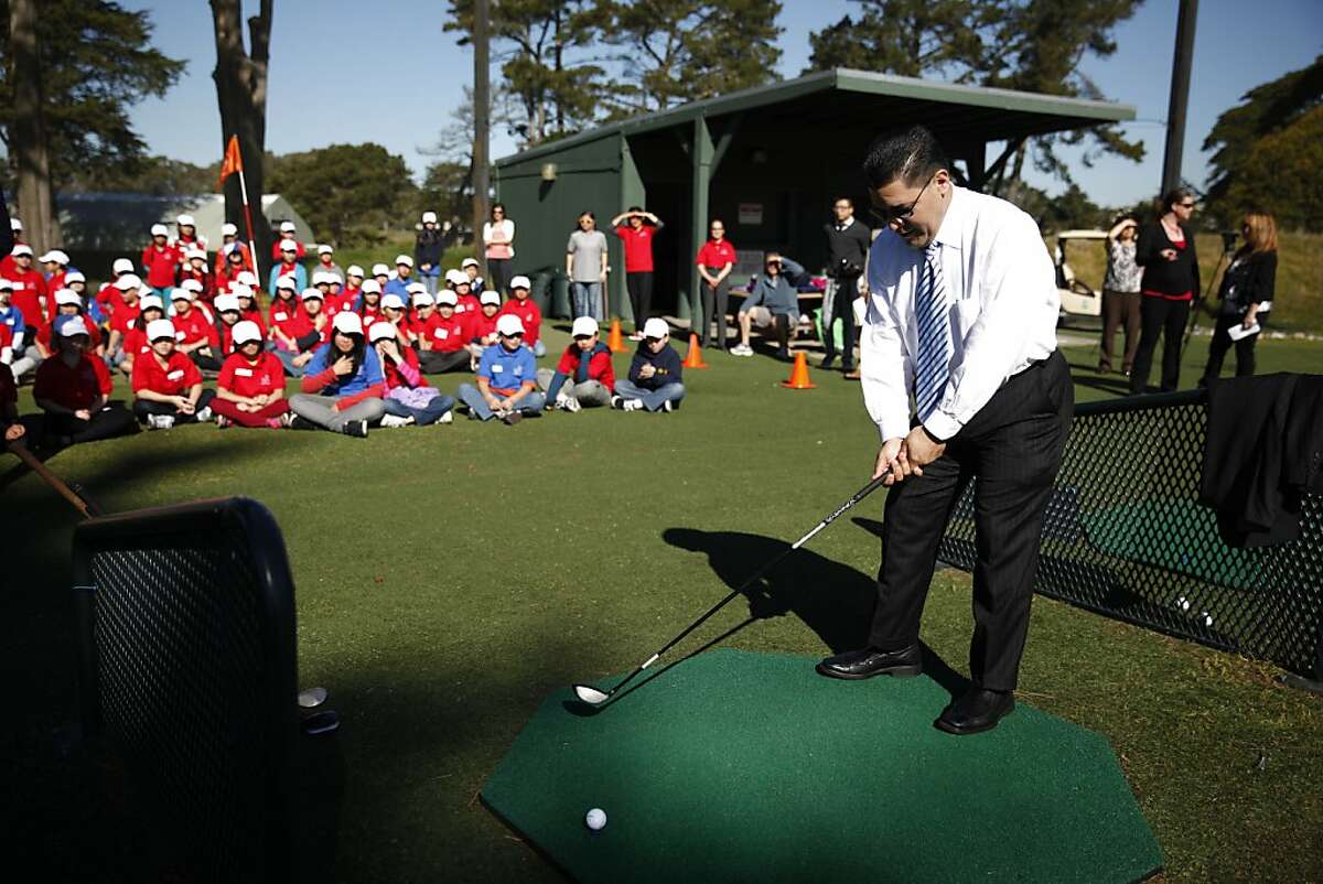 SFUSD Supervisor Richard Carranza prepares to hit a long drive as Lawton Alternative School fifth graders watch during a "First Tee" golf class at TPC Harding Park on Friday, February 15, 2013 in San Francisco, Calif. Carranza was there to congratulate the students on completing the "First Tee" golf program.