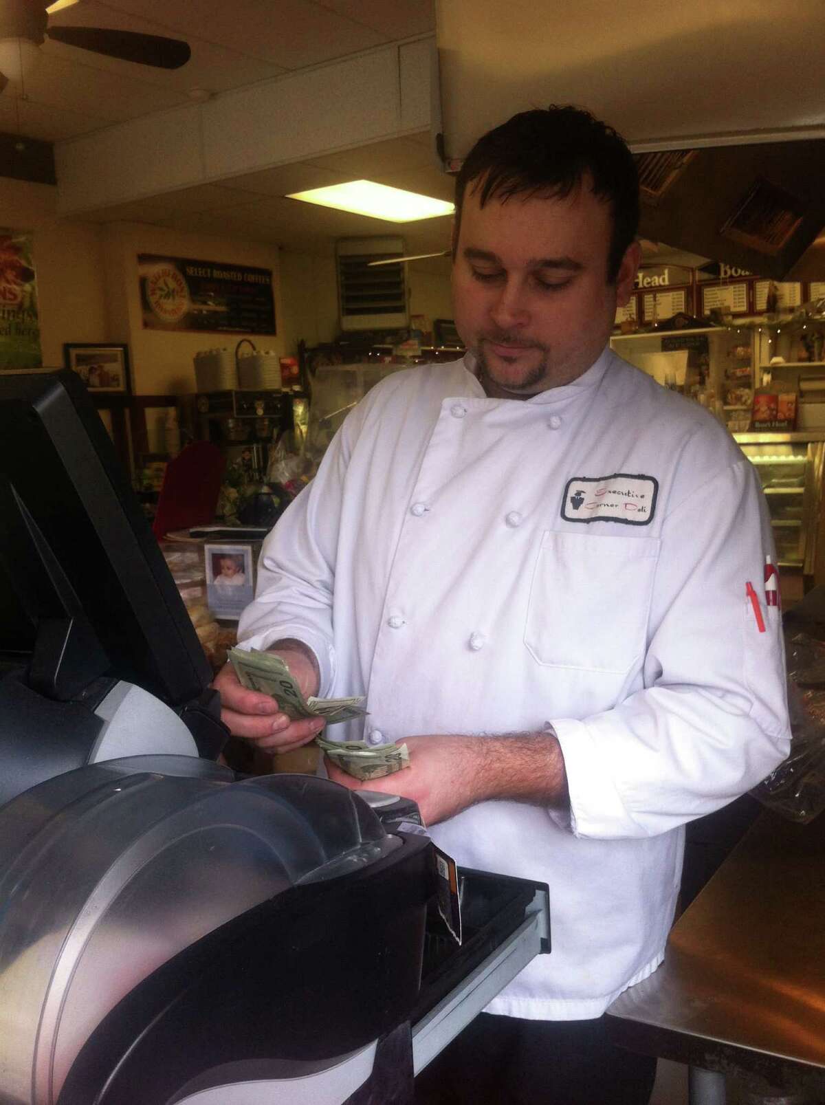 Kevin Allmashy, owner and executive chef of Executive Corner Deli & Catering, behind the register at the Byram store Saturday, Feb. 16, 2013. A man passed a counterfeit $100 bill to a store employee the afternoon of Feb. 13, Allmashy said.