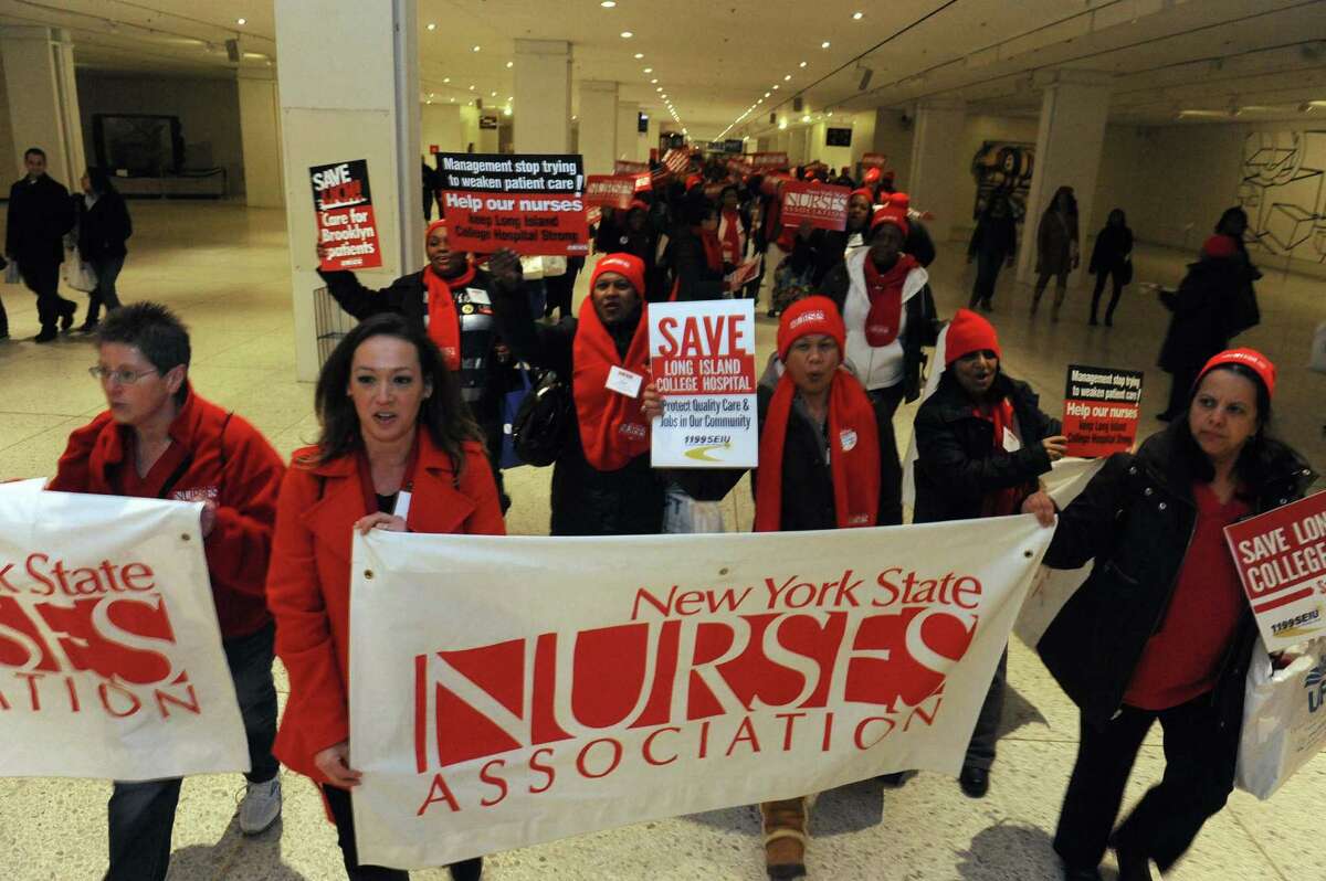 Nurses and patients march through the Empire State Plaza Concourse to protest plans to close several downstate hospital and allow hedge funds to establish for-profit hospitals at the Capitol on Saturday Feb. 16, 2013 in Albany, N.Y. .(Michael P. Farrell/Times Union)