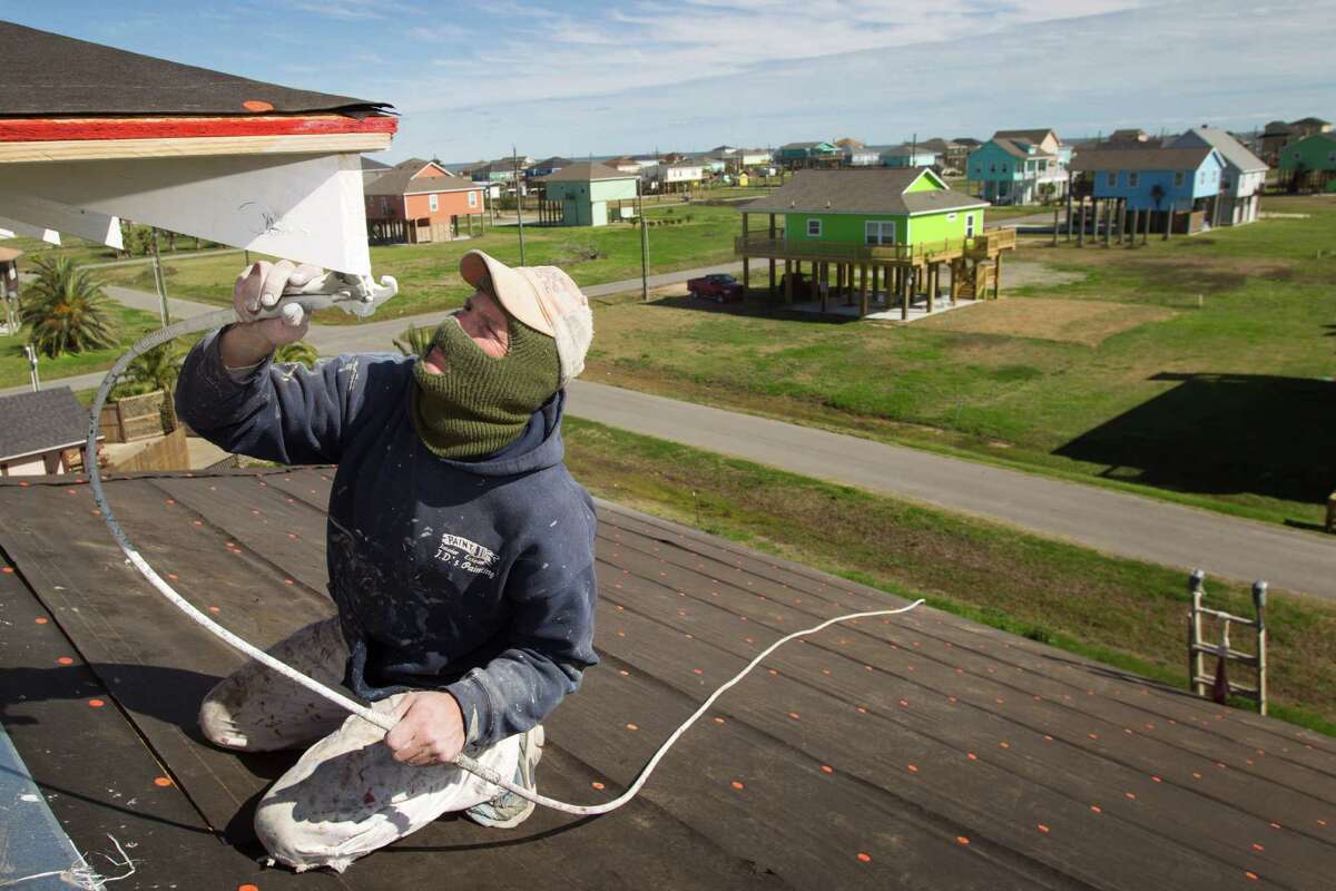 Jimmy Wiggins of Acadian Builders works last week on a new home under construction as newly built homes can be seen in the background in Crystal Beach, as the Bolivar Peninsula is experiencing a comeback