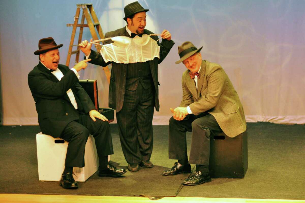 Actors P.J. Morello, Vic Terenzio and David Victor rehearse a scene on a train with an underwear salesman for the upcoming production of "The 39 Steps" at the Darien Arts Center Stage.