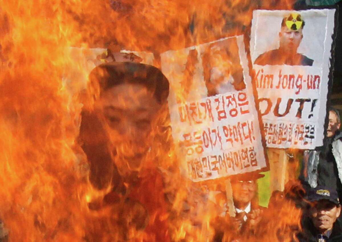 South Korean protesters burn an effigy of North Korean leader Kim Jong Un during an anti-North Korea rally denouncing the North's nuclear test in Seoul, South Korea, Wednesday. A day after North Korea defied U.N. warnings with a nuclear test, Pyongyang's neighbors turned to the business of bolstering their military preparations and sending out scientists to determine whether the detonation was as successful as the North claimed.