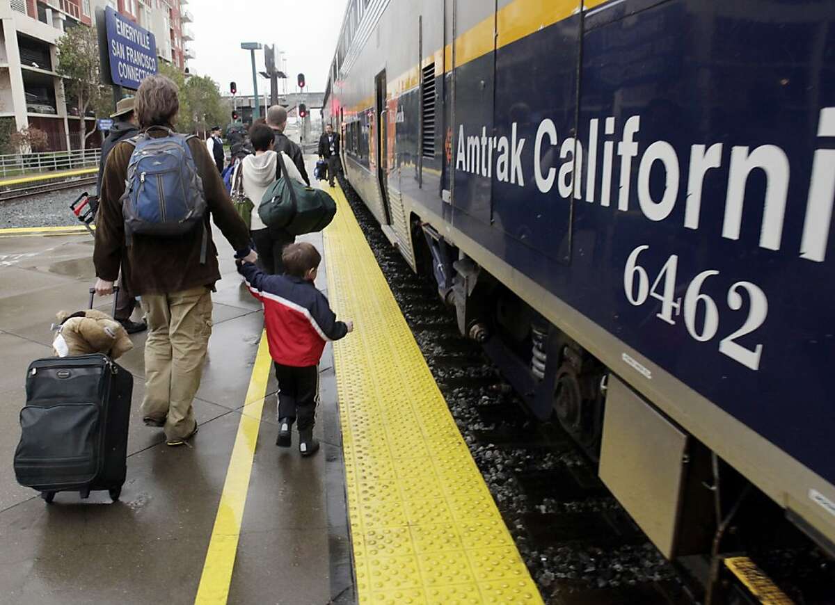 Barton Saunders and his son, Hayden Saunders, 3, of Los Angeles, prepare to board the Capitol Corridor Amtrak train at the Emeryville, Calif., station on Tuesday, December 28, 2010. While high-speed rail in California is getting all the attention, the state's lower-speed intercity trains are seeing a boom in popularity. Trains like the Capitol Corridor, shown here on Thursday, December 23, 2010, in Emeryville, Calif., have seen a double digit rise in passengers.