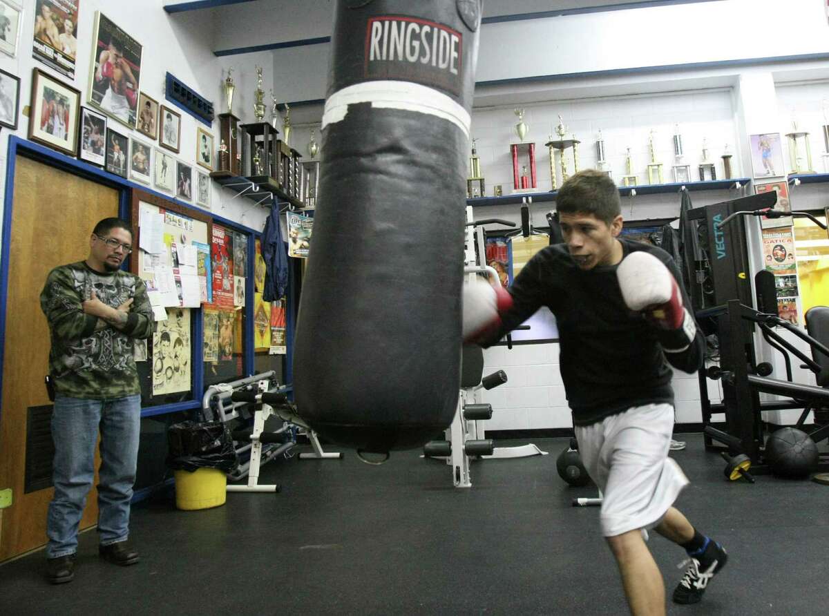 Johnny Garcia, 45, helps train his son Nicholas, 19, at Calderon Boys & Girls Club. The younger Garcia will be making his amateur debut in the local Golden Gloves tournament this week.
