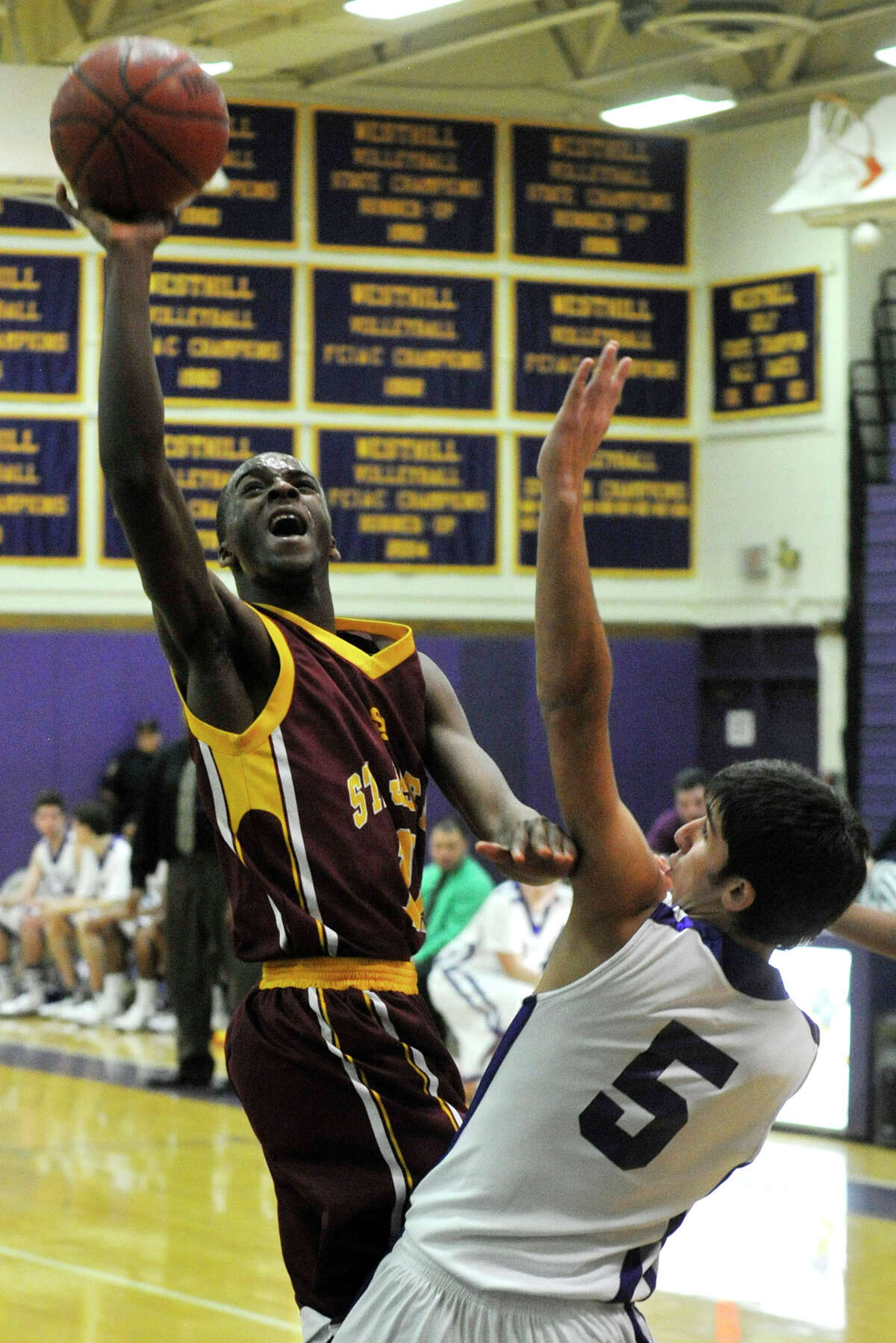 St. Joseph's Quincy McKnight shoots over Westhill's Evan Skoparantzas during their game at Westhill High School in Stamford on Monday, Feb. 18, 2013. St. Joseph won, 63-61.